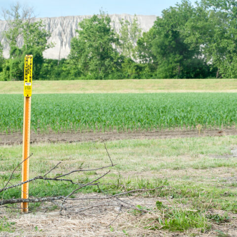 Field with pipeline marker in view
