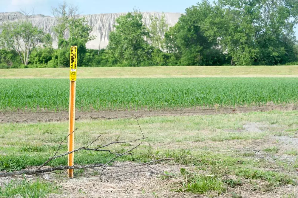 Field with pipeline marker in view